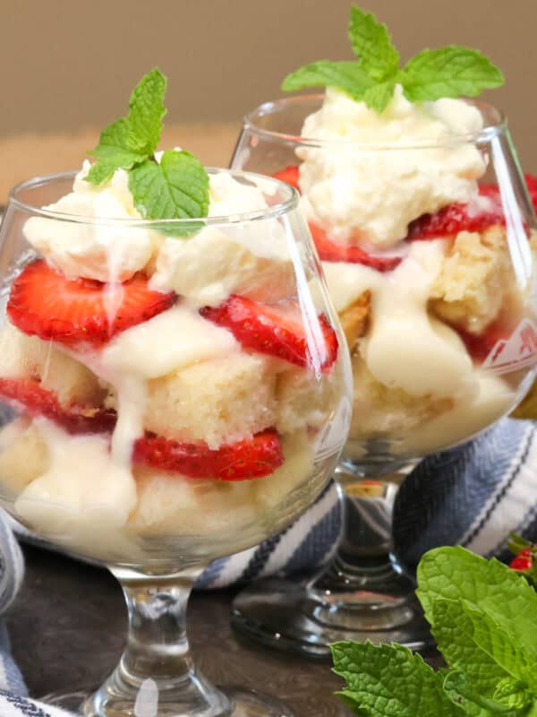 two trifles on a silver tray next to a blue napkin.