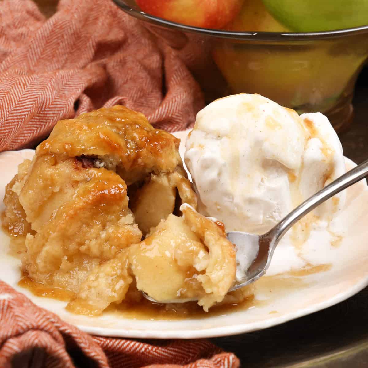 a partially eaten apple dumpling on a plate.