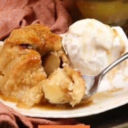 a partially eaten apple dumpling on a plate.