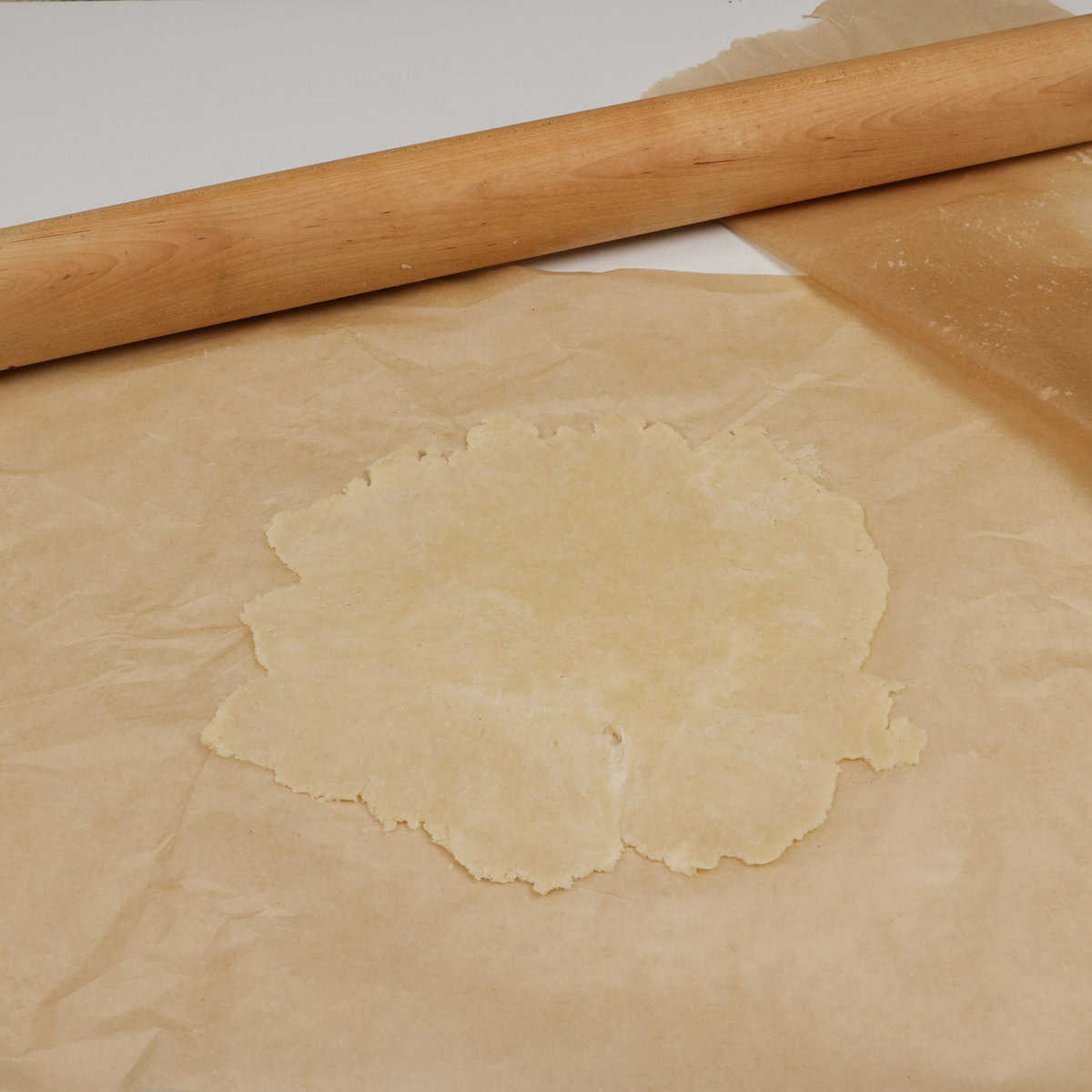 rolled pie crust on parchment paper.