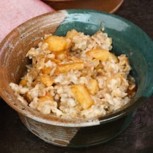 a bowl of oatmeal topped with spiced apples.