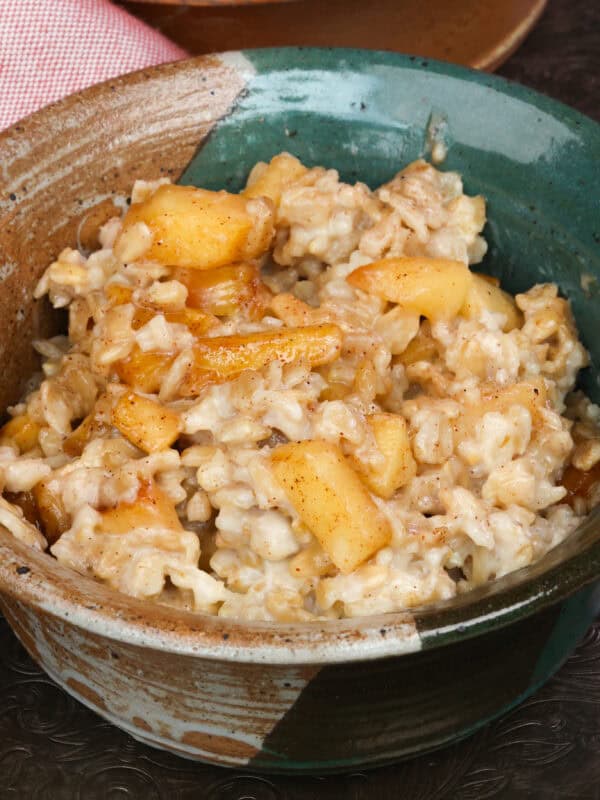 a bowl of oatmeal topped with spiced apples.