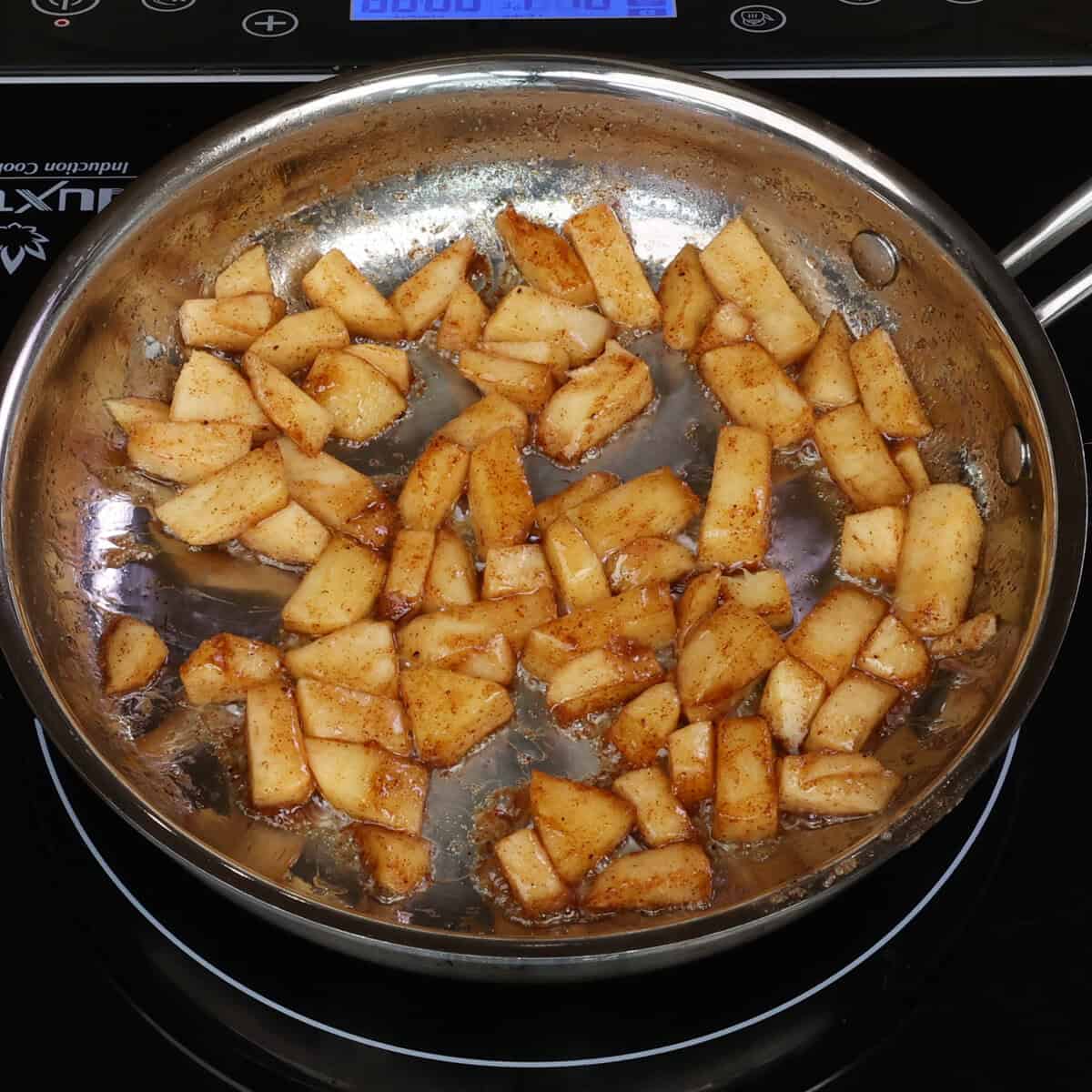 sauteed apples in a skillet.