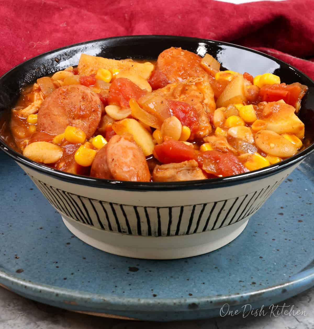 a bowl of brunswick stew on a blue plate.