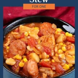 a bowl of brunswick stew next to a red napkin.