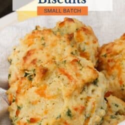 four cheese biscuits in a bread basket.