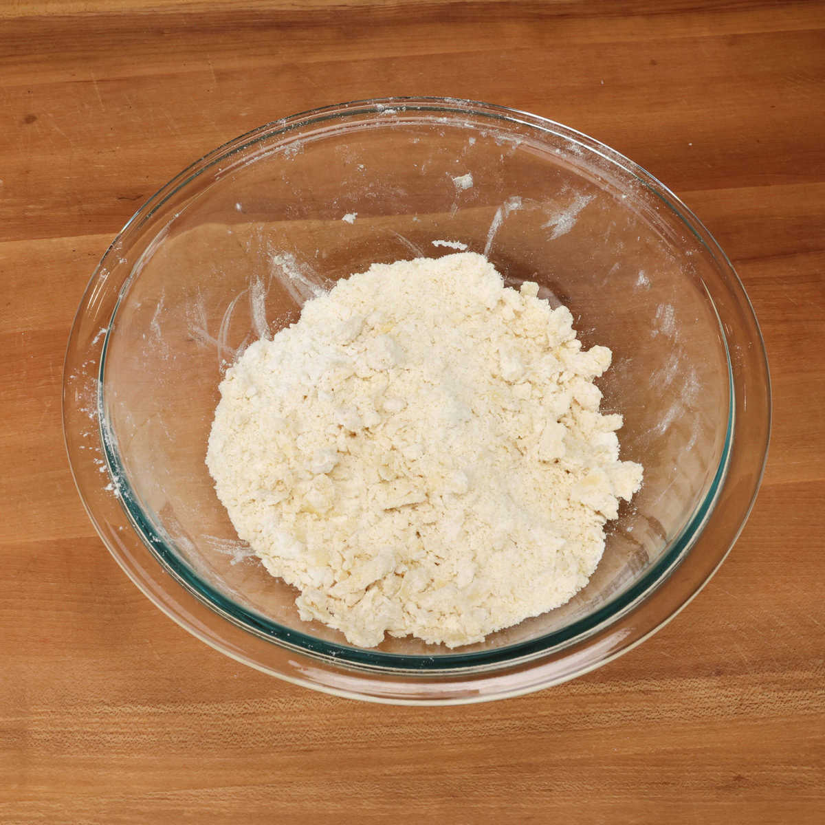 cold butter mixed into dry ingredients in a mixing bowl.