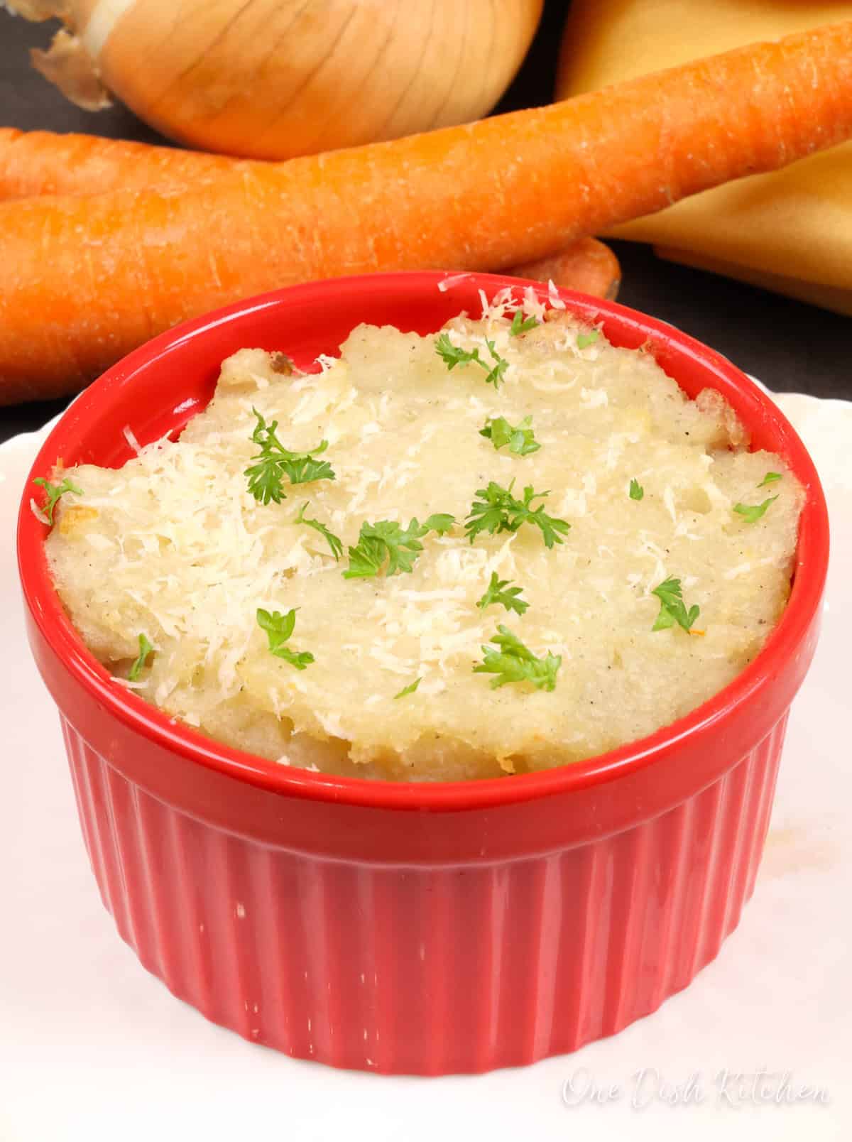 a small cottage pie on a white plate.