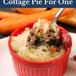 cottage pie in a ramekin with a spoon on the side.