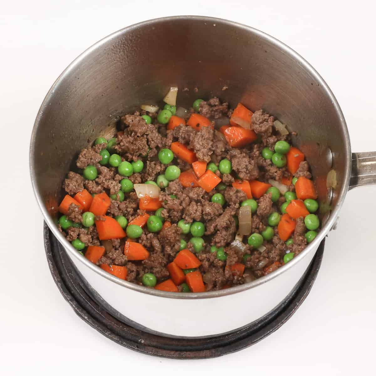 cottage pie filling simmering in a small pot.