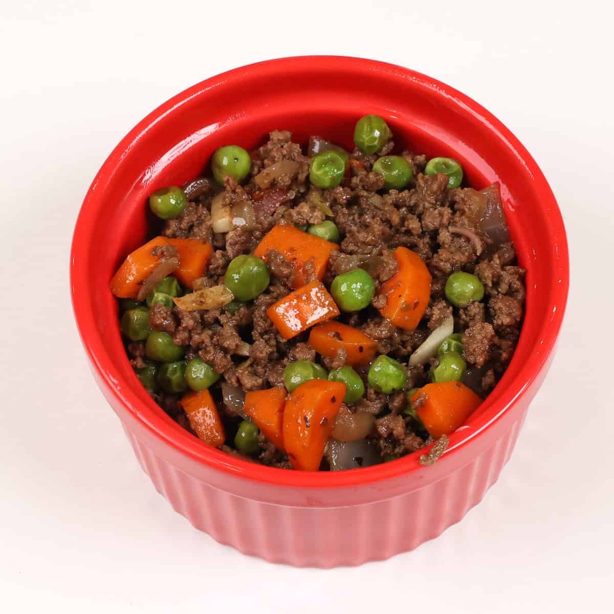 cottage pie filling in a small red ramekin.