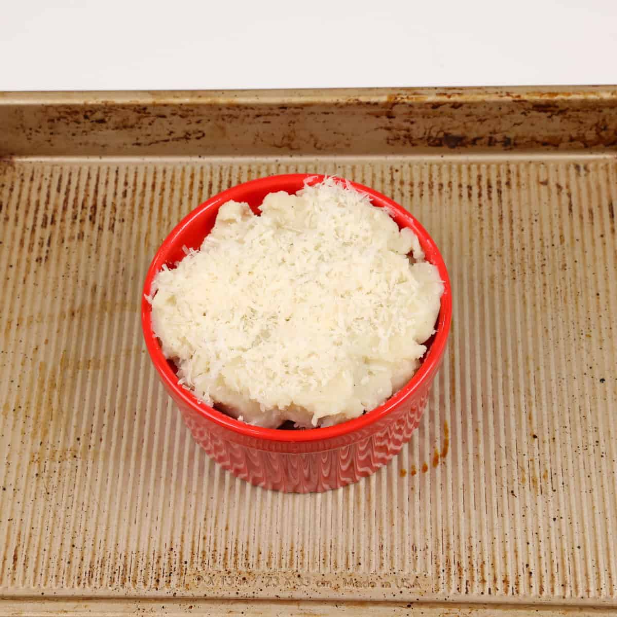 an unbaked cottage pie on a rimmed baking sheet.