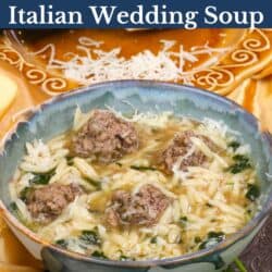 a bowl of Italian Wedding Soup next to a plate of fresh Parmesan cheese.