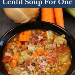 a bowl of lentil soup topped with parmesan cheese.