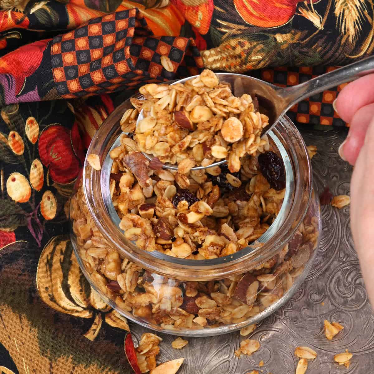 a spoonful of maple granola above the jar.