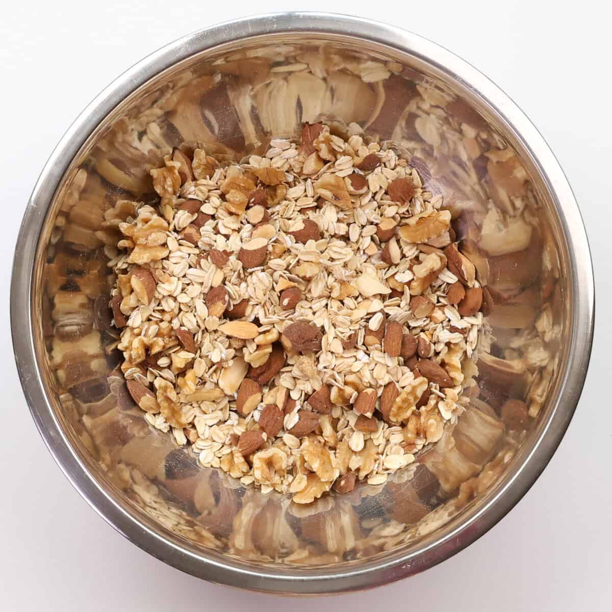 oats, nuts, brown sugar, and spices in a mixing bowl.