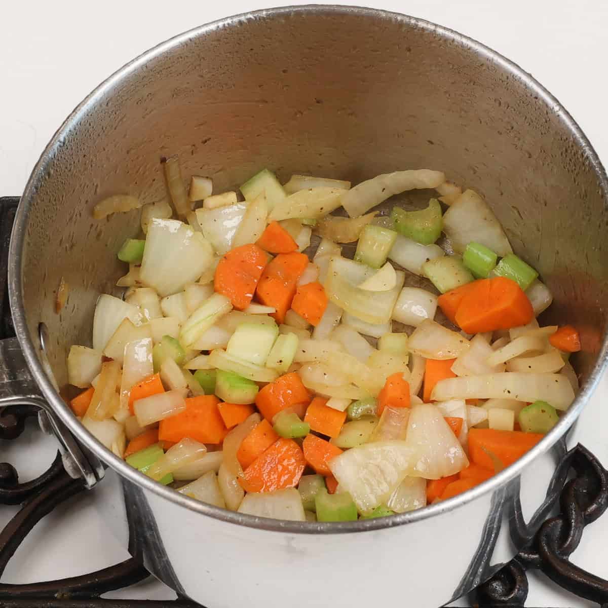 onions, celery, carrots and garlic sauteeing in a pot.