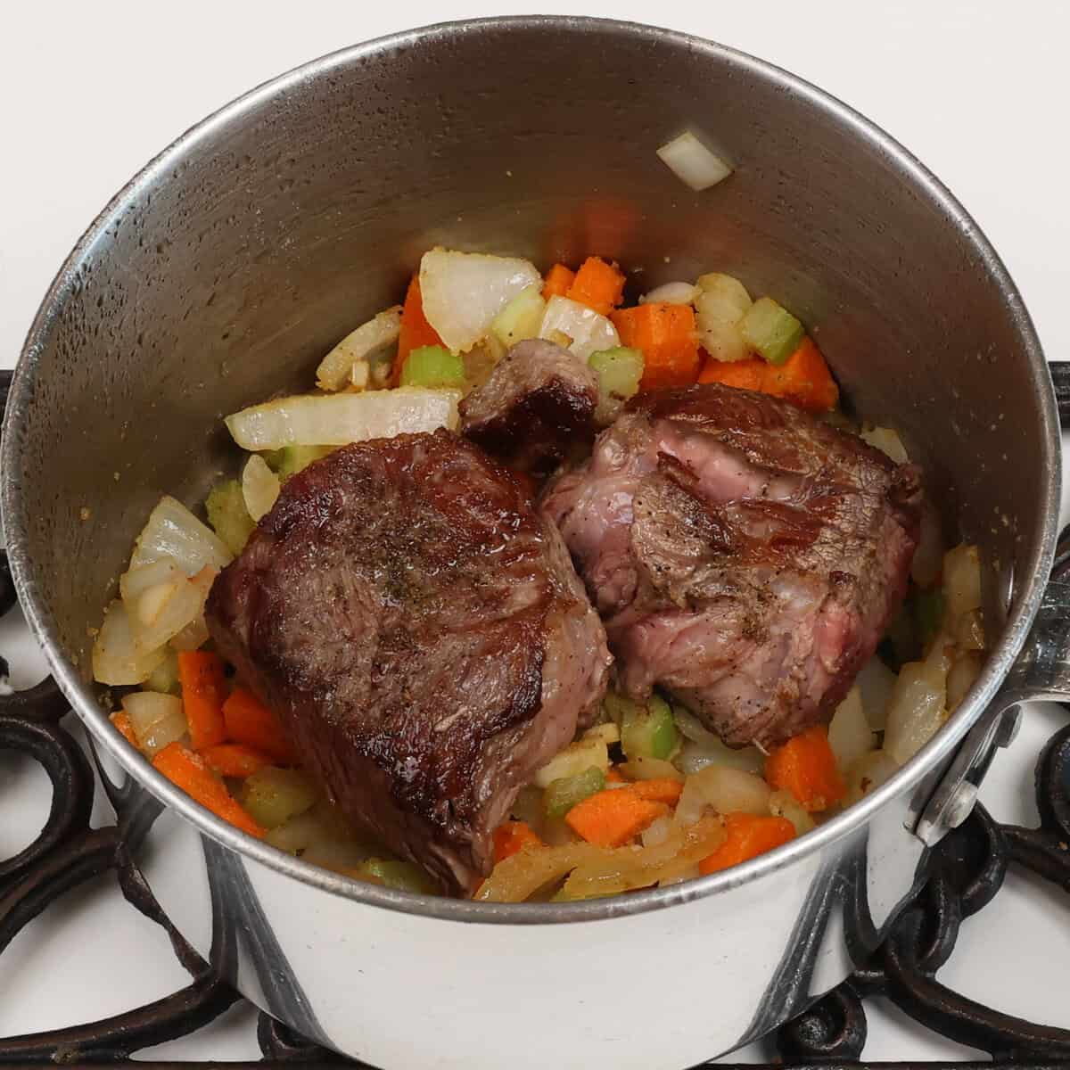 roast on top of vegetables in a pot.