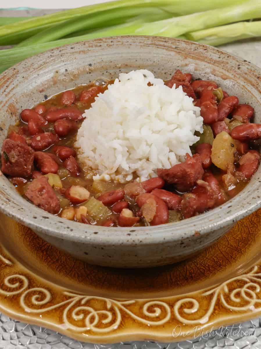 a bowl of red beans and rice with sausage.