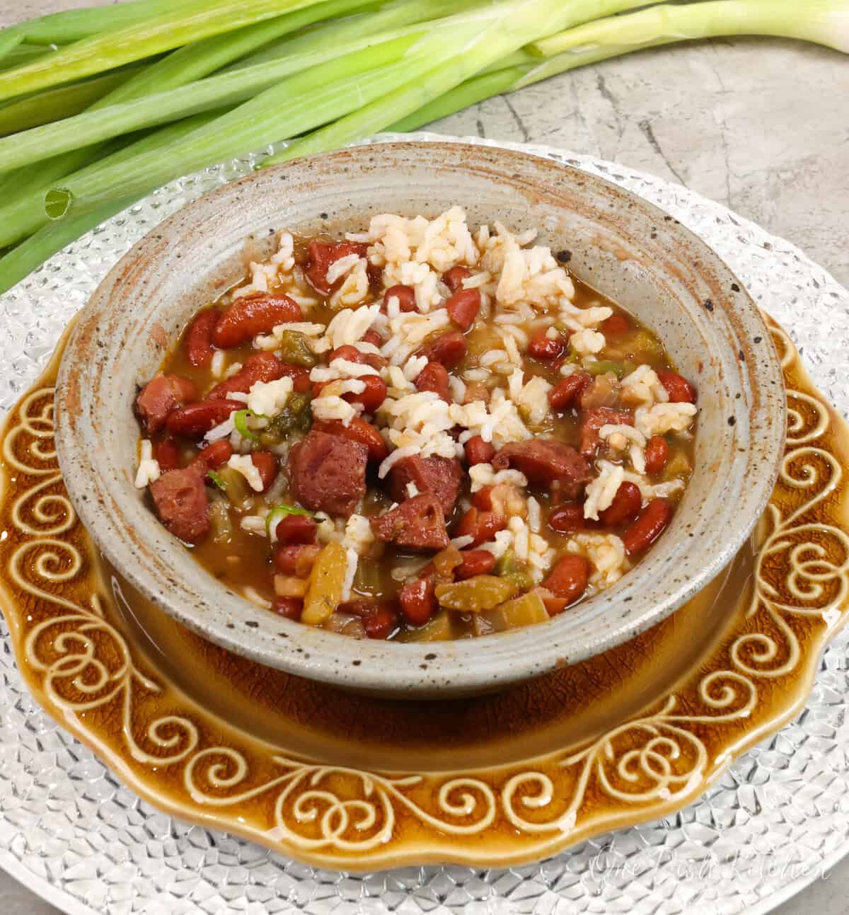 red beans mixed together with rice, sausage, and vegetables in a bowl.