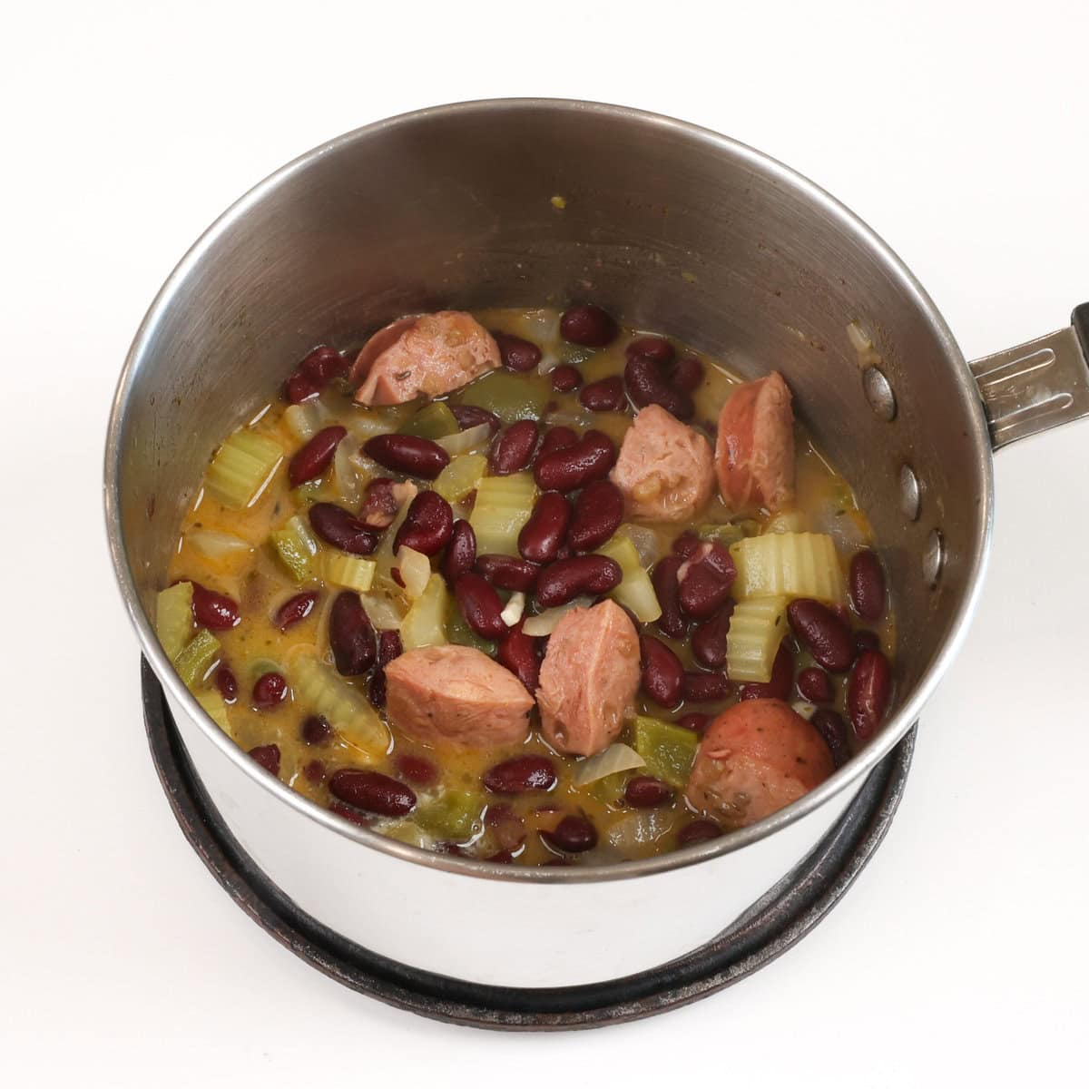 red beans with rice and sausage in a small pot.