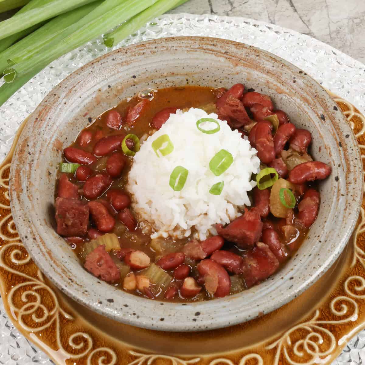 red beans and sausage with rice and a bowl.