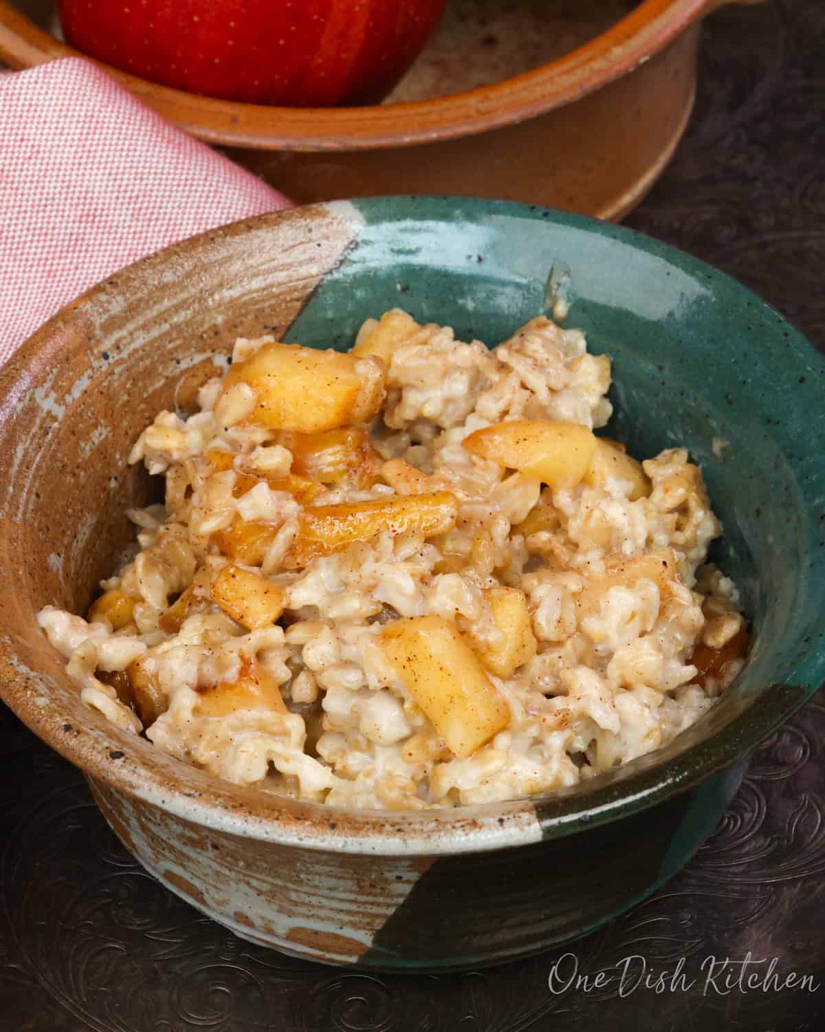 a bowl of oatmeal topped with spiced apples.