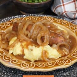 bangers and mash on a gold plate.