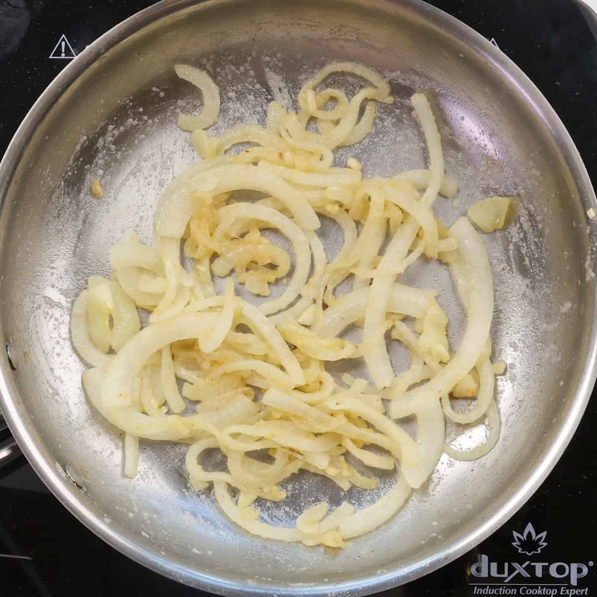 sauteed onions and garlic mixed with flour in a skillet.