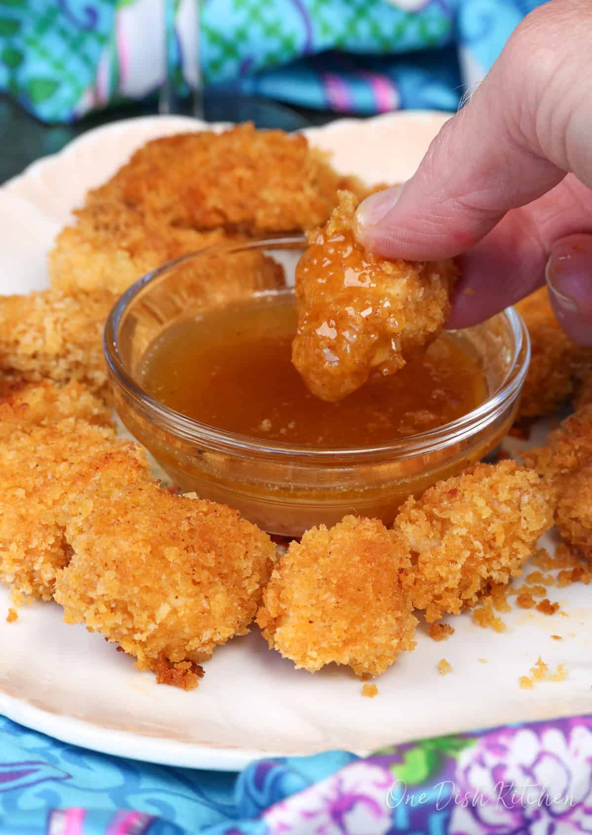 popcorn chicken with a dipping sauce.