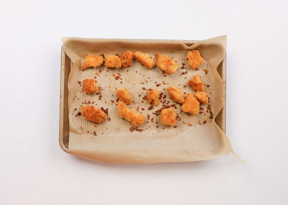 baked popcorn chicken on a baking sheet.