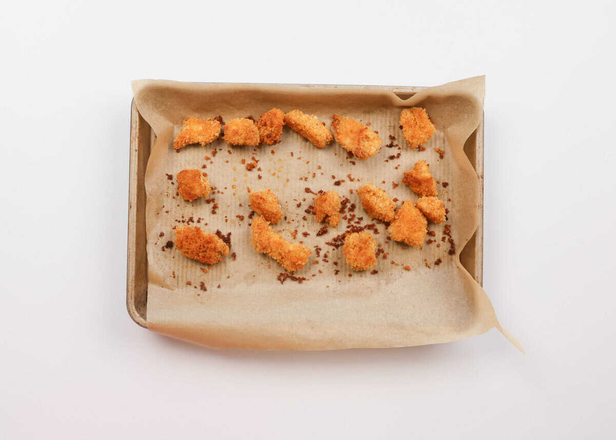 baked popcorn chicken on a baking sheet.