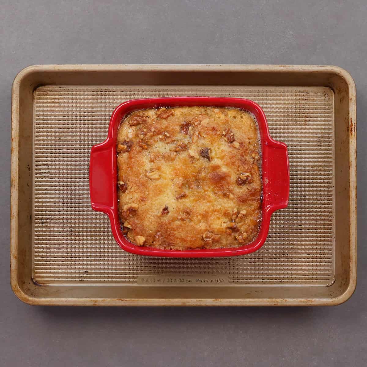 a small pumpkin dump cake cooling on a baking sheet.