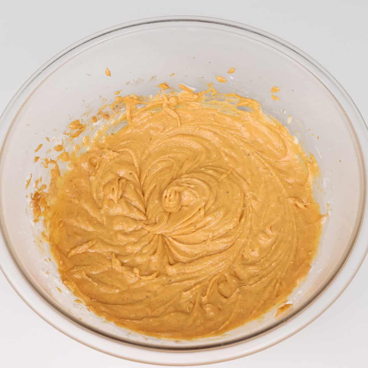 pumpkin muffin batter in a mixing bowl.