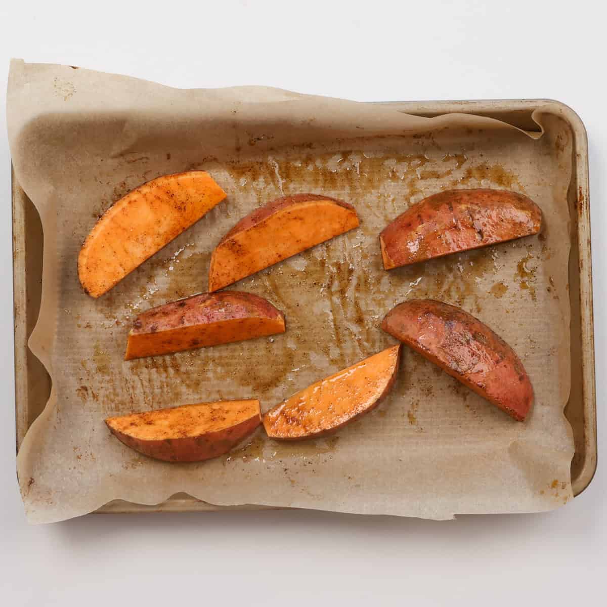 unbaked sweet potatoes on a baking sheet.