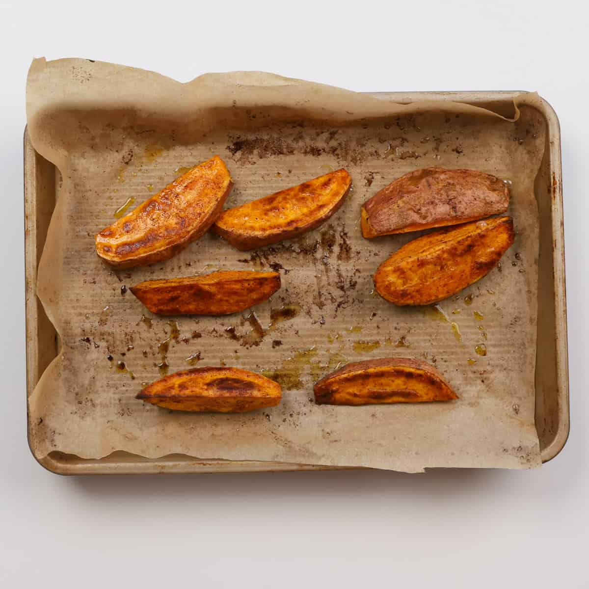 baked sweet potato wedges on a baking sheet.