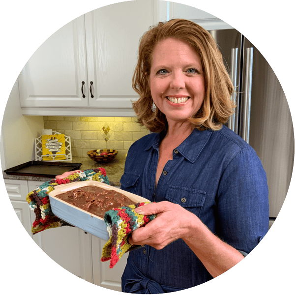 joanie zisk holding a mini chocolate cake.