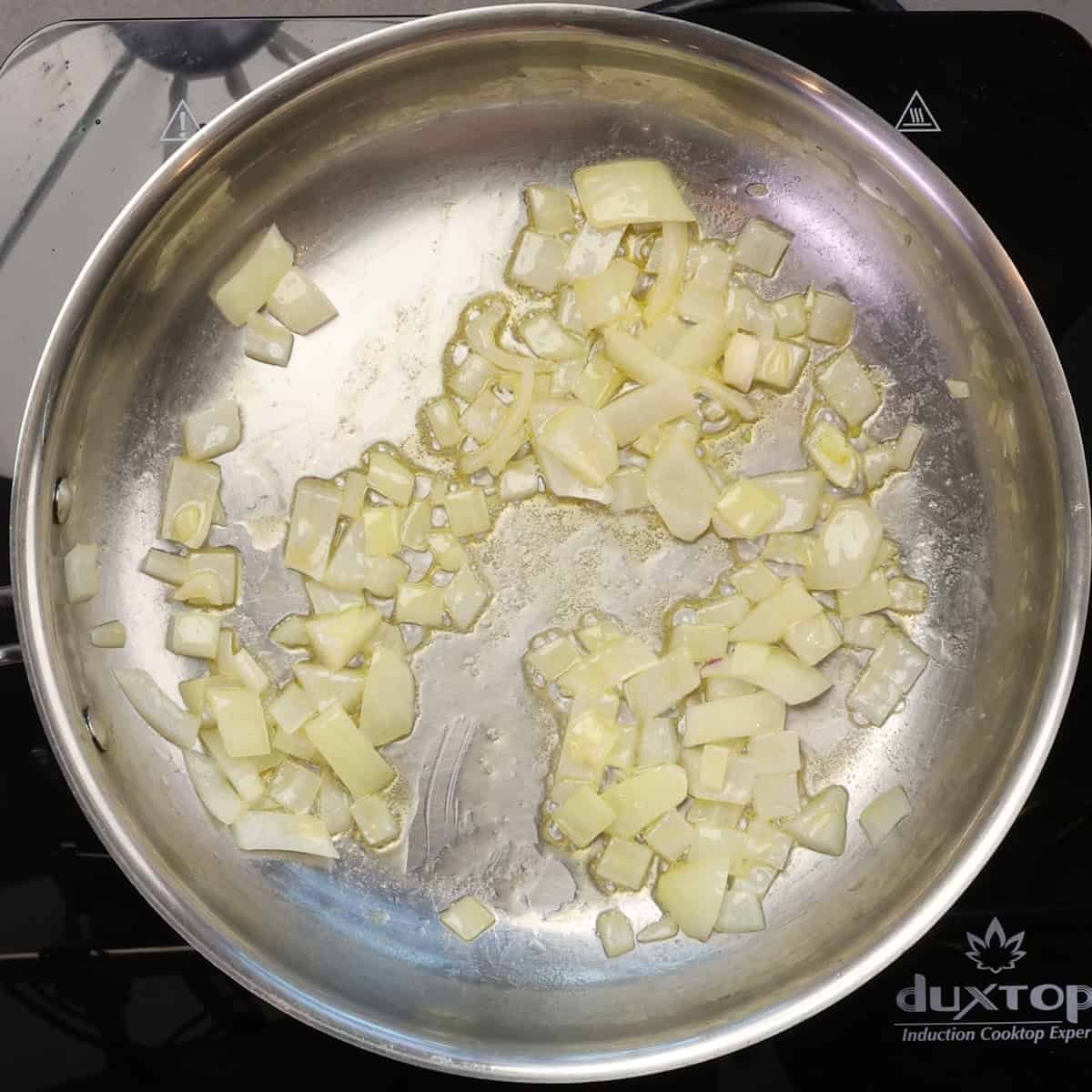 onions cooking in butter in a skillet.