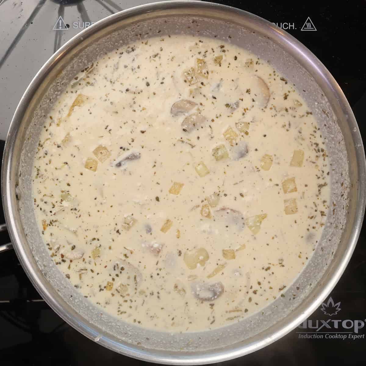 a creamy mushroom sauce simmering in a skillet.