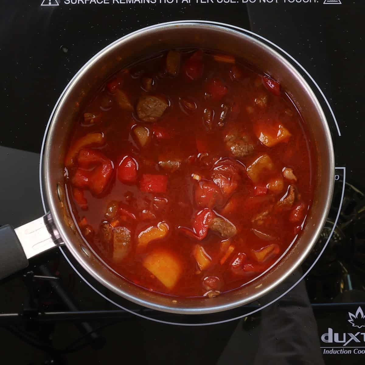 hungarian goulash simmering on the stove.