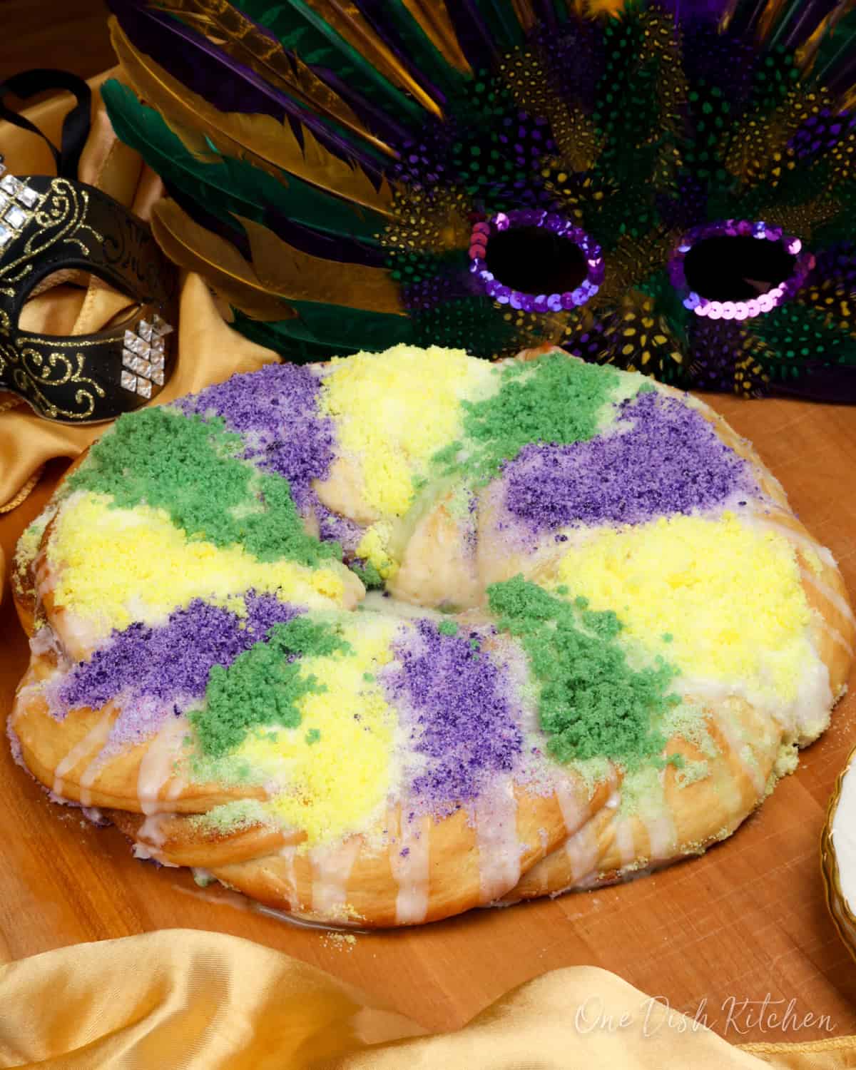 A Mini King Cake with cinnamon sugar, cream cheese filling, and festive Mardi Gras colors.