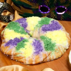 a mini king cake with a cream cheese filling and topped with colored sugar.