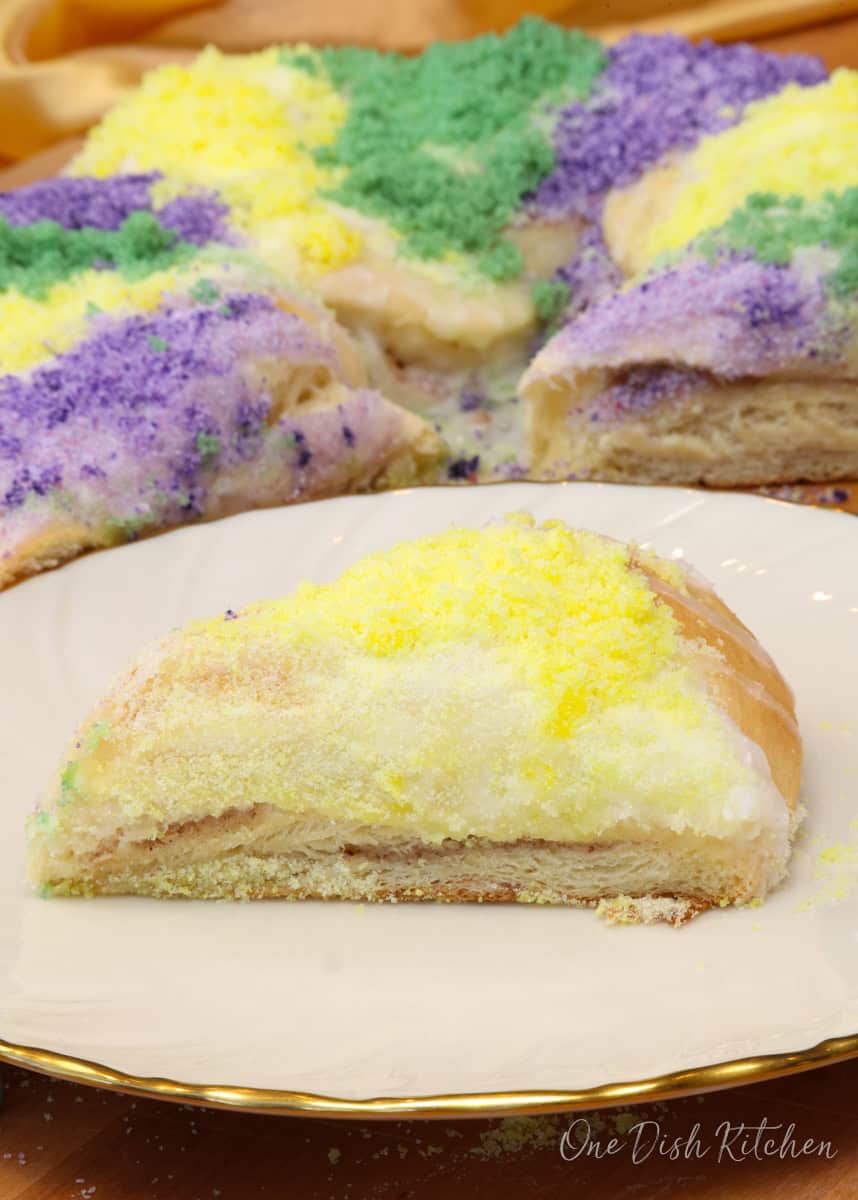  a slice of king cake on a plate.