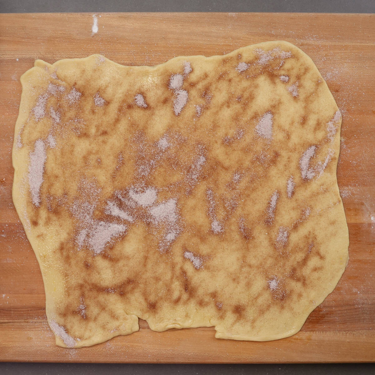 cinnamon sugar sprinkled on top of the rolled king cake dough.