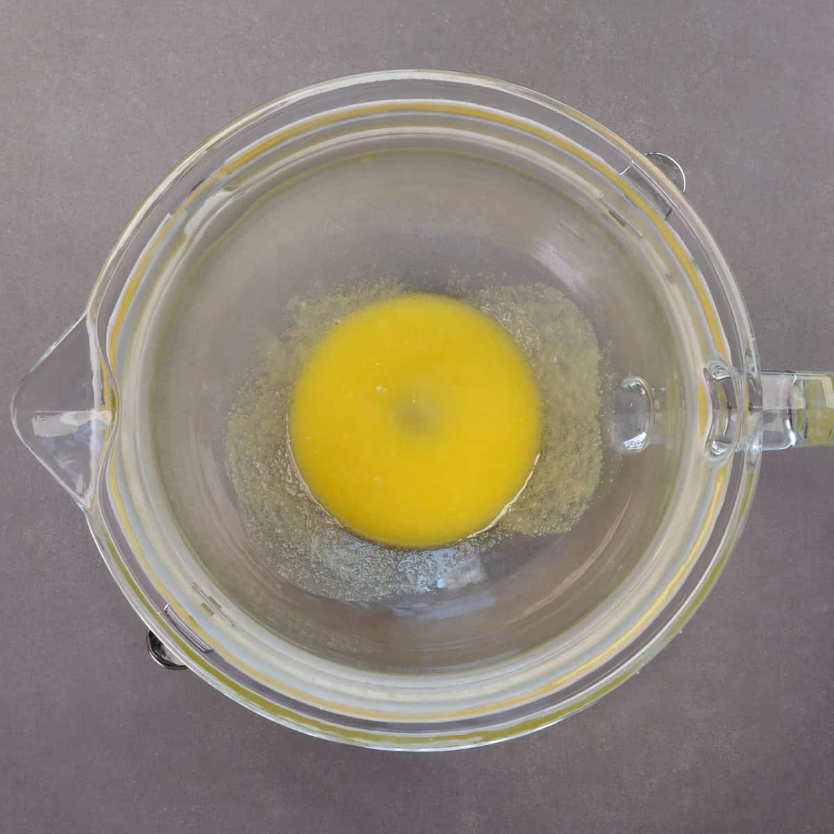 melted butter and sugar in a mixing bowl.