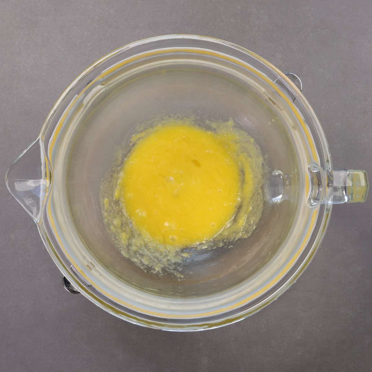 an egg mixed with butter and sugar in a mixing bowl.