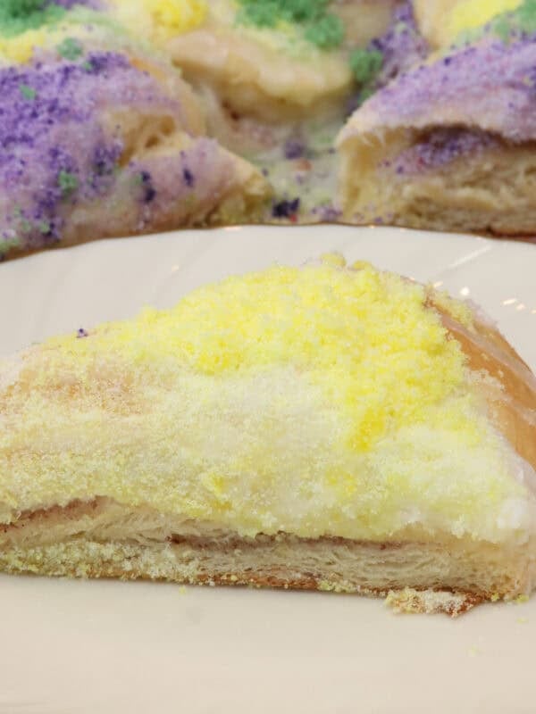 a slice of king cake on a white plate.