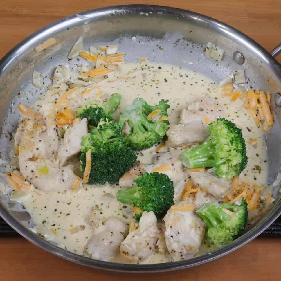 broccoli, chicken and sauce in a pan.