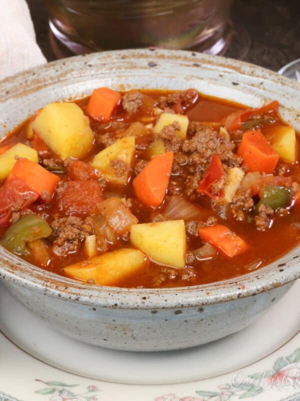 a blue bowl filled with hamburger soup.