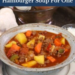 a blue bowl filled with hamburger soup.